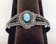A Vintage Fred Harvey Sterling Silver Bracelet With A Turquoise Cabochon Center