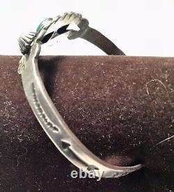 A vintage sterling silver Fred Harvey cuff bracelet with a turquoise cabochon