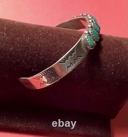 A vintage sterling silver Fred Harvey turquoise bracelet. Excellent condition